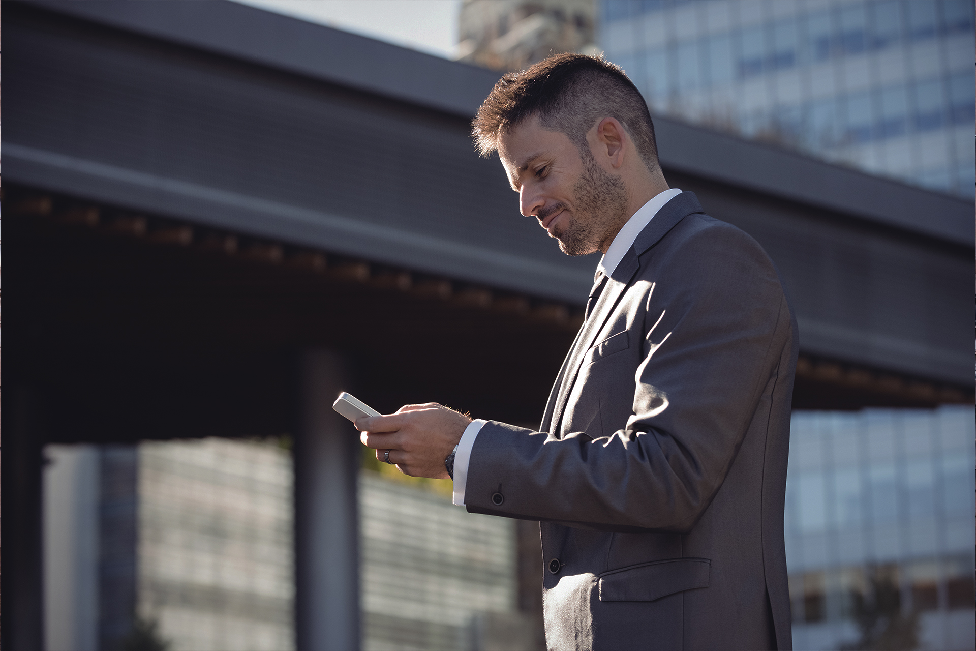 Beginner investor holding a smartphone with stock market app, symbolizing how to start investing with $100.